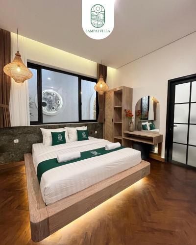 a bedroom with a large bed in a room at Sampai Villa Prambanan in Randugunting