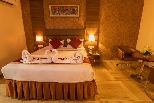 two swans carved into a bed in a hotel room at Hotel SVM Grand Medipally in Upal