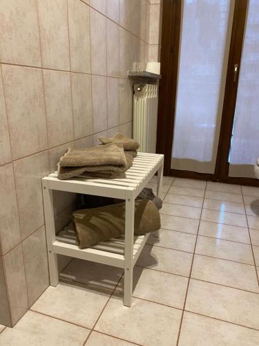 a white table in a bathroom with towels on it at Appartamento ONE in Novara