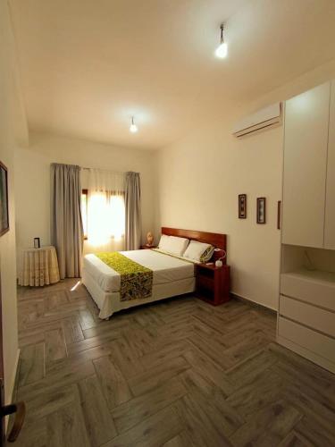 a bedroom with a large bed and a window at Nhambavale Niara House in Chidenguele