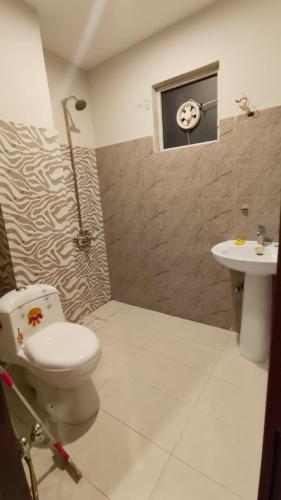 a bathroom with a toilet and a sink at Hotel 26 in Islamabad
