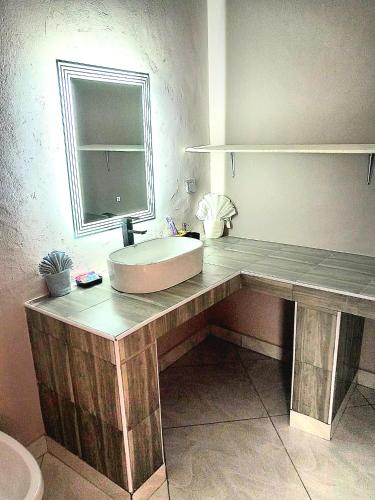 a bathroom with a sink and a mirror at Villa SunShine exclusive in Watamu
