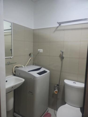 a small bathroom with a toilet and a sink at Staycation in Tropez 924 in Manila