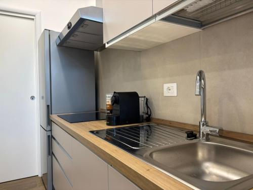 a kitchen with a sink and a microwave at SARA - interno 1 - Premium Villas in Giulianova
