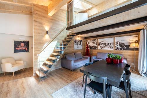 a living room with a table and a staircase at Residence Bosco Verde in San Cassiano