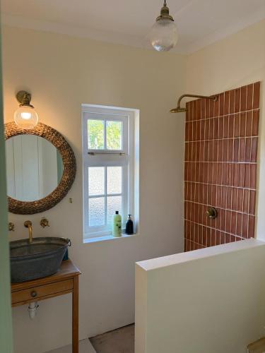a bathroom with a sink and a mirror at Poplar Karoo Escape in Prince Albert