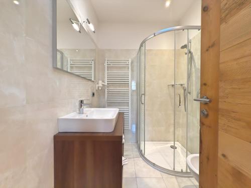 a bathroom with a sink and a shower at Cesa Dolomia Apartments in Canazei