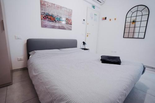 a bed in a bedroom with a black bag on it at 2D - Home 32 Apartments in Modena