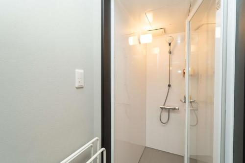 a bathroom with a shower with a glass door at 三十三Tsuki in Kyoto