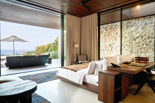 a bedroom with a bed and a desk and a couch at Maxx Royal Bodrum in Golturkbuku