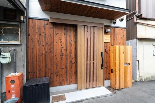 a front door of a house with a wooden fence at 三十三Tsuki in Kyoto