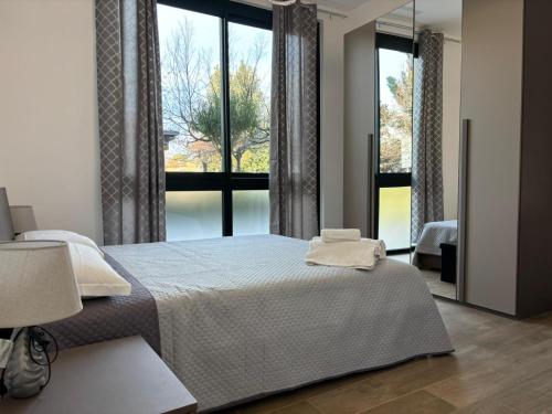 a bedroom with a bed and a large window at SARA - interno 1 - Premium Villas in Giulianova