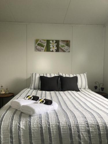 a bedroom with a bed with two towels on it at Hideaway on Honikiwi in Otorohanga