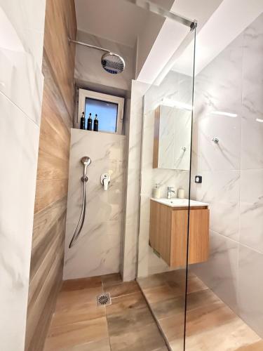 a bathroom with a shower and a sink at Dvillas one bedroom apartment in Svoronata