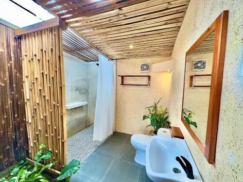 a bathroom with two toilets and a sink at MareCoves Resort & Glamping in Cilangkahan