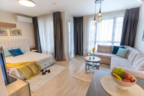 a living room with a bed and a couch at Azur Alegria Luxury Studio with Pool Access in Saints Constantine and Helena
