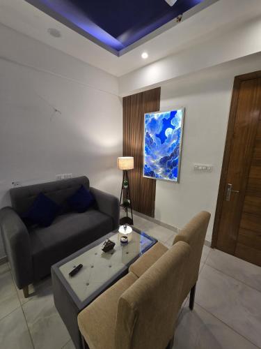 a living room with a couch and a table at The Mulberry Silk - Blue Saphire in Noida