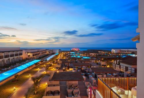 a view of a resort with a pool at night at Meliá Laguna Beach - Adults Only in Santa Maria
