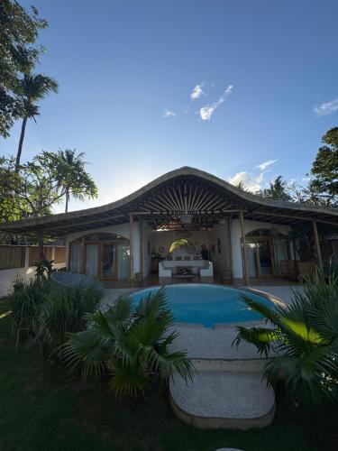 a house with a swimming pool in the yard at You & Me Private Villa in Gili Islands