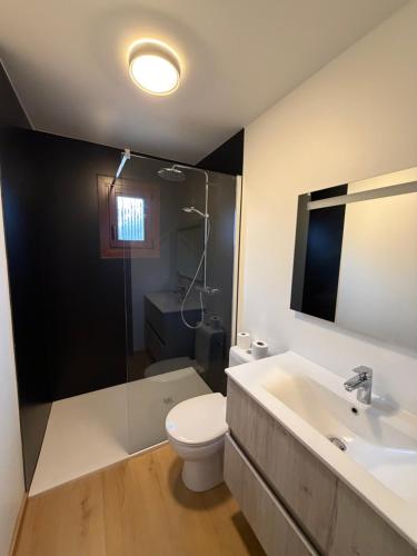 a bathroom with a toilet and a sink at Coeur de bois - 19 in Petit Mesnil