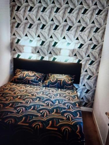 a bedroom with a bed with a wall at Cap ô sud 2 in Cannes