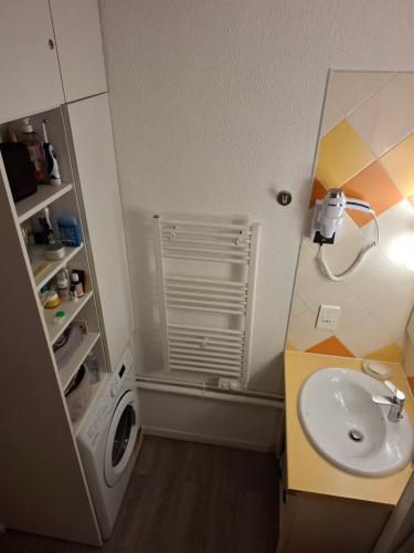 a bathroom with a sink and a washing machine at Cap ô sud 2 in Cannes