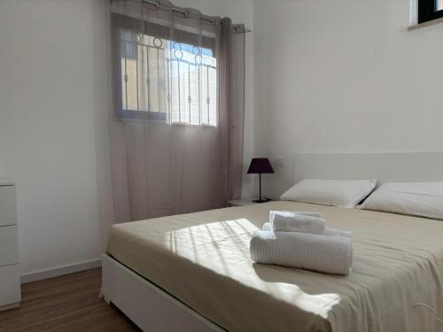a white bedroom with a large bed with a window at SARA - interno 2 - Premium Villas in Giulianova