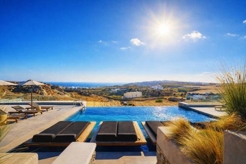 a swimming pool with a view of the ocean at Evi Suites & Villas in Mikonos