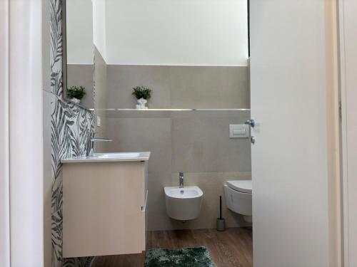 a white bathroom with a sink and a toilet at SARA - interno 2 - Premium Villas in Giulianova