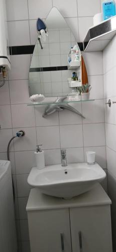 a bathroom with a sink and a mirror at Apartman Marcel in Nijemci