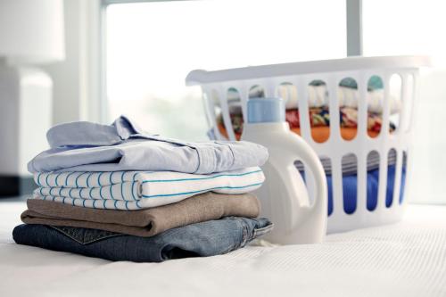 a pile of towels and a bottle of laundry detergent at Hyatt House Dallas Lincoln Park in Dallas