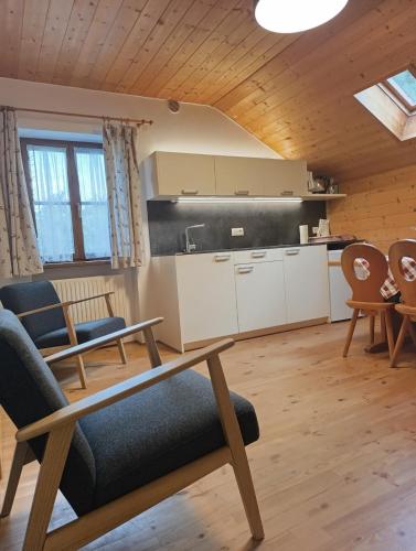a living room with a table and chairs at Brunelle, Obertörgglerhof in Brixen