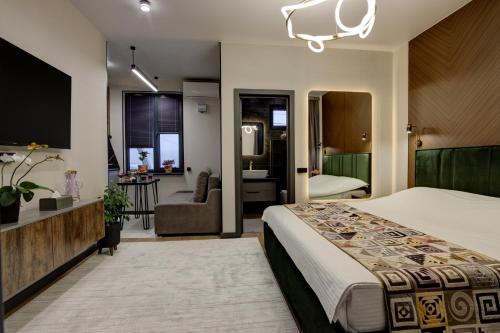 a hotel room with a bed and a bathroom at EV Hotel Baytik in Verkhnyaya Alaarcha