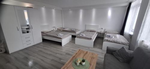 a living room with two beds and a table at Goldberg Apartments in Kassel
