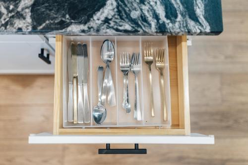 a utensil holder with forks and spoons at Indulge in SoCo Vibes at New 2024 Home with Outdoor TV & Heavenly Bed in Austin