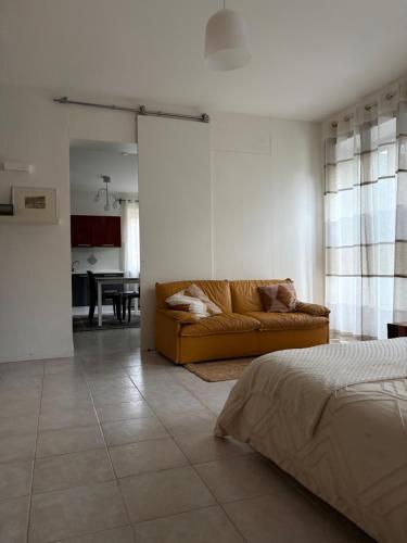 a bedroom with a couch and a living room at Posticino apartment in Soave
