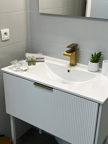 a white bathroom with a sink and a mirror at One minute to the Beach in Menton