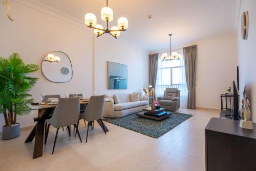 a living room with a table and a dining room at Yas Island 1BR - Chic Luxe Retreat in Abu Dhabi