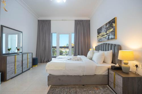 a bedroom with a large bed and a large window at Yas Island 1BR - Chic Luxe Retreat in Abu Dhabi