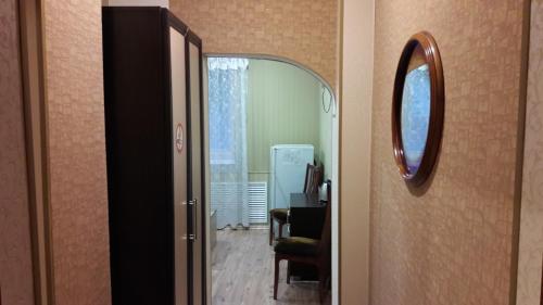 a hallway with a mirror and a room with a table at Hotel Sergeevskiy in Gomel