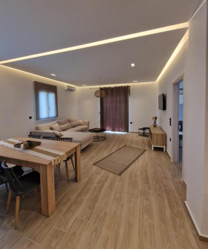 a living room with a couch and a table at Amelie apartments in Naxos Chora