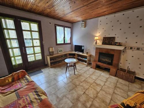 a living room with a desk and a fireplace at Gîte la salle in Vivonne