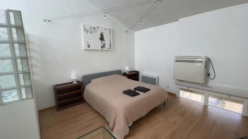 a bedroom with a bed and a air conditioner at test in Saint-Avertin