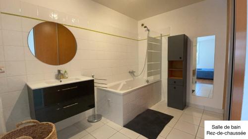 a bathroom with a tub and a sink and a bath tub at test in Saint-Avertin