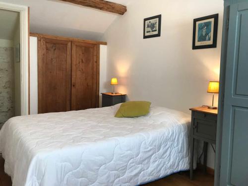 a bedroom with a white bed and two lamps at Gîte lamarlière in Savigny-sous-Faye