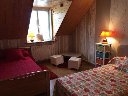 a small bedroom with a bed and a window at La prée in Seligny