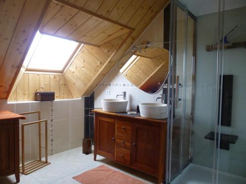 a bathroom with a shower and a sink and a window at La prée in Seligny