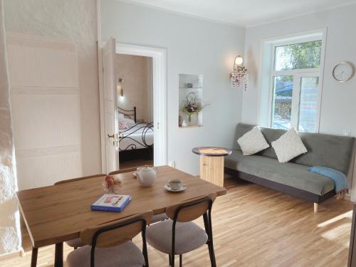 a living room with a table and a couch at Romantic Old Town Hideaway in Haapsalu