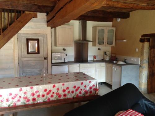 a kitchen with a table in the middle of it at Le moulin de preuillé in Valence en Poitoux