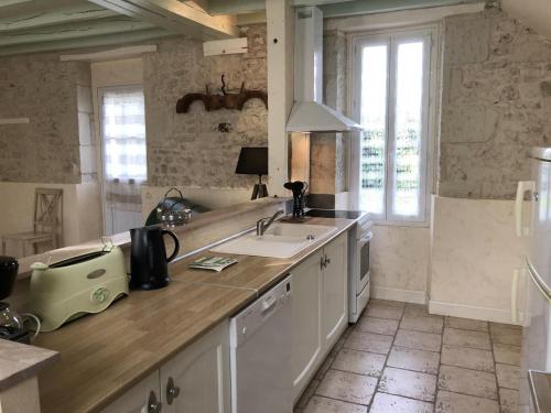a kitchen with a sink and a counter at L'althéa in Saint-Gervais-les-Trois-Clochers